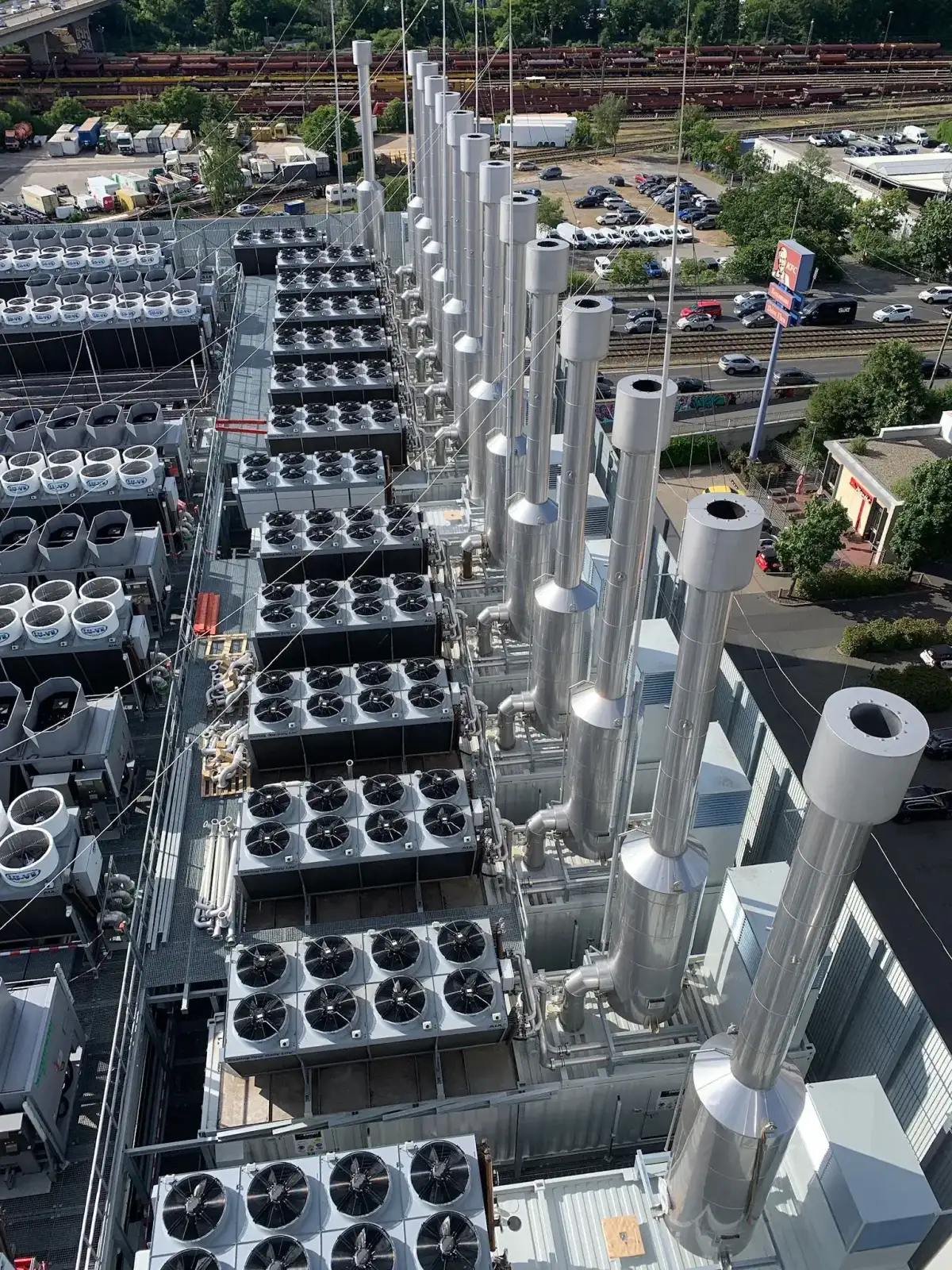 Integrated exhaust silencer and self-supporting chimney systems for a hyperscale datacenter in Germany